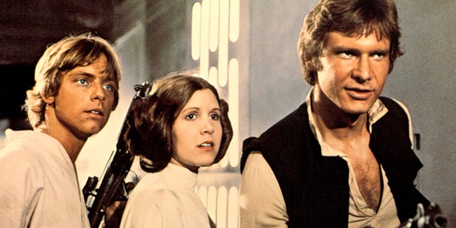 "Star Wars" (aka "Episode IV-A New Hope") lobby card, with three of the most famous characters in movie history. From left, Luke Skywalker (played by Mark Hamill), Princess Leia (Carrie Fisher) and Han Solo (Harrison Ford) 