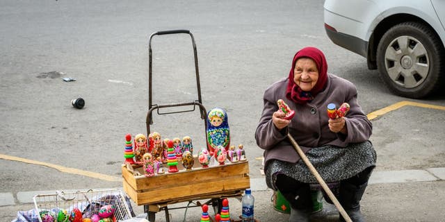 A woman sells Easter eggs and Russian souvenirs on a street in central Moscow on April 20, 2019. (Mladen Antonov / AFP via Getty Images)