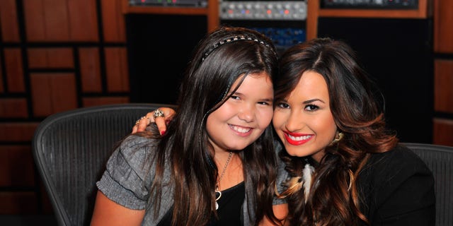 Actress and singer Demi Lovato, right, and actress sister Madison De La Garza in 2011.