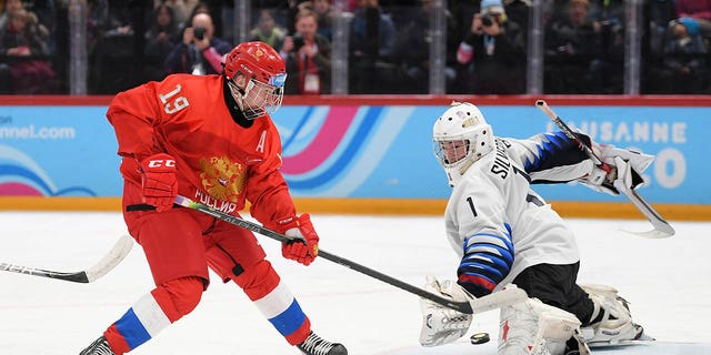 Dylan Silverstein, right, and Matvei Michkov of Russia battle for the puck during the Men's 6-Team Ice Hockey Tournament Finals Gold Medal Game between Russian Federation and United States on day 13 of the Lausanne 2020 Winter Youth Olympics at Lausanne Vaudoise Arena on Jan. 22, 2020 in Lausanne, Switzerland.