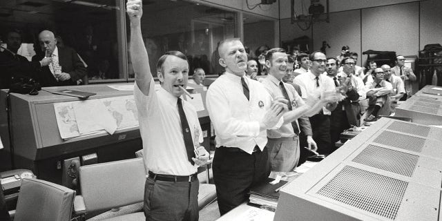 Apollo 13 - NASA, 1970. Mission Control Center, Houston, Texas: Three of the four Apollo 13 flight directors applaud the successful splashdown of the Command Module Odyssey, April  17, 1970. Artist NASA. 