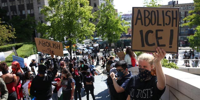 Protesters rally outside City Hall on July 12, 2020, in Seattle. Demonstrators called for the abolishment of U.S. Immigration and Customs Enforcement (ICE) and its immigration detention centers. 