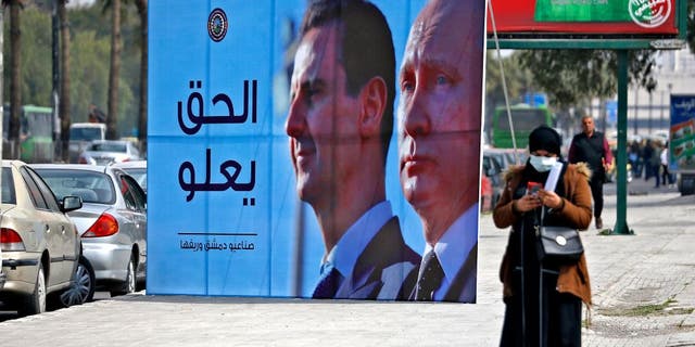 Assad- und Putin-Werbetafel