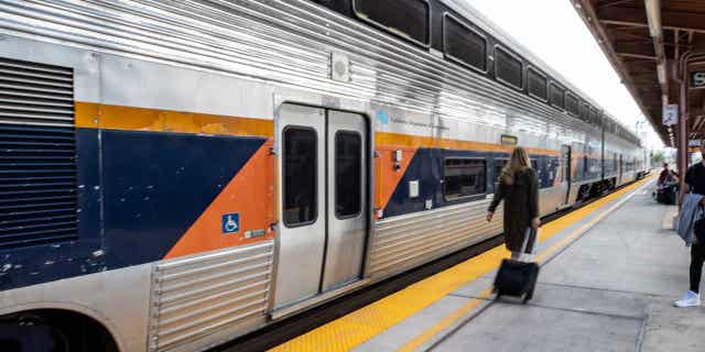 A woman walks on the train platform at the Diridon Amtrak Station in San Jose, California, on Sept. 14, 2022. Amtrak and Metrolink train services in Southern California are set to be restored next week following months of repairs.