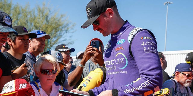 Cody Ware (#51 Rick Ware Racing Nurtec ODT (Rimegepant) Ford) signs autographs before the NASCAR Cup Series Championship Race on November 6, 2022 at Phoenix Raceway in Avondale, Arizona. (Photo by