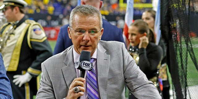 Fox Sports announcer Urban Meyer talks on air during half-time of the Purdue Boilermakers playing against the Michigan Wolverines on December 3, 2022, during the Big 10 Football Championship at Lucas Oil Stadium in Indianapolis, Indiana. 