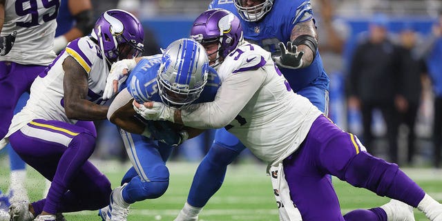 Detroit Lions wide receiver Amon-Ra St. Brown, #14, is tackled by Minnesota Vikings defensive tackle Harrison Phillips, #97, during the second half of an NFL football game, Sunday, Dec. 11, 2022, in Detroit, Michigan, USA.  .