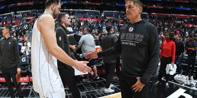 Luka Doncic of the Dallas Mavericks and team owner Mark Cuban shake hands during the game against the Los Angeles Clippers at Crypto.Com Arena in Los Angeles on Jan. 10, 2023.