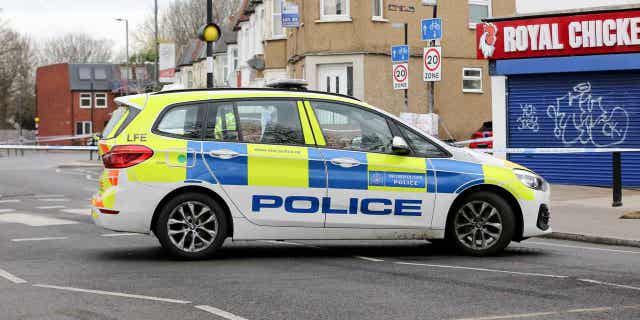 Police car outside a cordon on Arnold Road in Tottenham