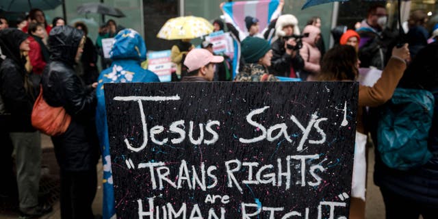 A sign reading Jesus says Trans Rights are Human Rights" is seen as LGBTQ activists protest on March 17, 2023, in front of the US Consulate in Montreal, Canada, calling for transgender and non-binary people be admitted into Canada.