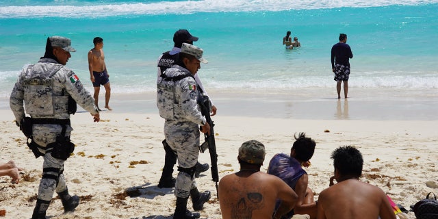 Mexican soldiers talk to spring breakers