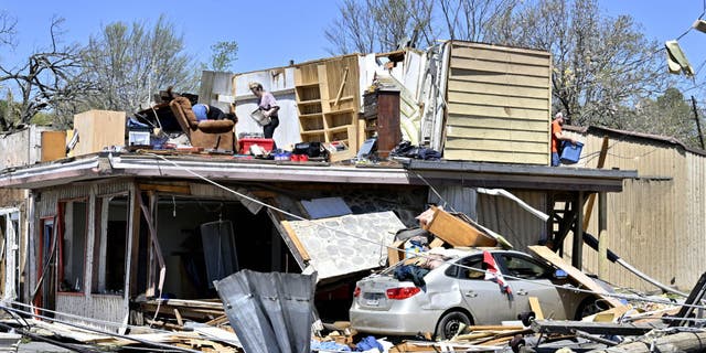 Building collapses killed several people across the country as severe storm systems and tornadoes swept through the Midwest.