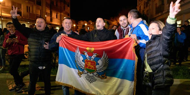 Montenegrin Serb nationalists hold an ancient flag of Montenegro as their candidate, Jakov Milatovic, won the second round of the presidential elections on April 2, 2023 in Podgorica, Montenegro.