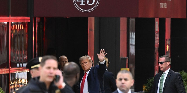 Former President Donald Trump waves as he arrives at Trump Tower in New York on April 3, 2023.