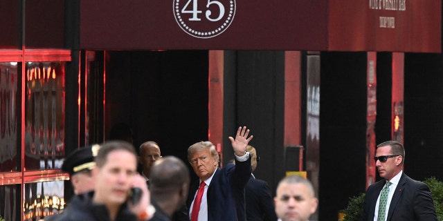 Former President Donald Trump waves as he arrives at Trump Tower in New York on April 3, 2023.