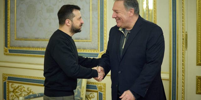 Ukrainian President Volodymyr Zelenskyy shakes hands with former Secretary of State Mike Pompeo in Kyiv on April 4, 2023.