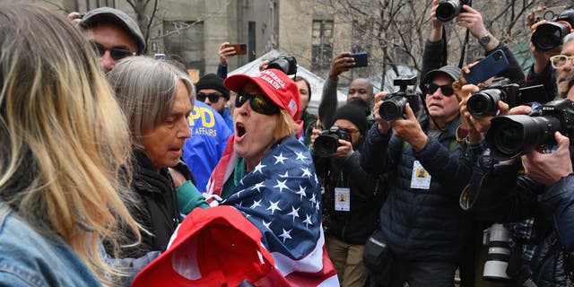 Pro- and anti-Trump supporters face off outside Manhattan Criminal Court in New York City on Tuesday.