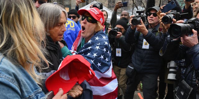 Pro- and anti-Trump supporters face off outside Manhattan Criminal Court in New York City on Tuesday.