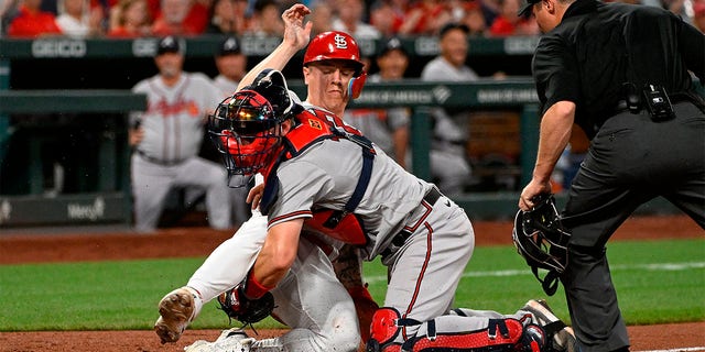 Tyler O'Neill of the Cardinals is tagged out at home by Sean Murphy of the Atlanta Braves at Busch Stadium on April 4, 2023, in St Louis.