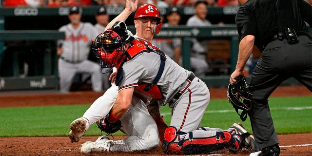 Tyler O'Neill of the Cardinals is tagged out at home by Sean Murphy of the Atlanta Braves at Busch Stadium on April 4, 2023, in St Louis.