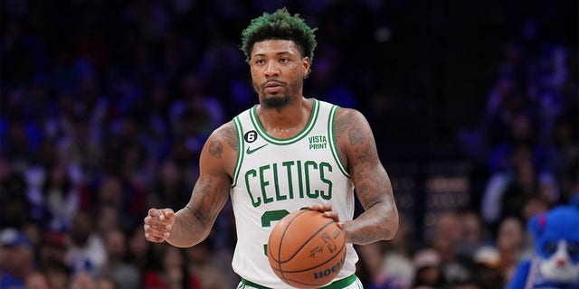 Marcus Smart of the Boston Celtics dribbles the ball against the Philadelphia 76ers on April 4, 2023, at the Wells Fargo Center in Philadelphia.