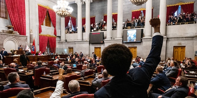 Democratic state representatives Justin Jones (lower left) of Nashville and Justin Pearson (center) of Memphis gesture to supporters during a vote in which they were expelled from the state legislature April 6, 2023, in Nashville.