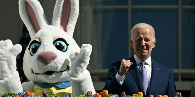 US President Joe Biden, alongside the Easter Bunny (L), gestures after speaking at the annual Easter Egg Roll on the South Lawn of the White House in Washington, DC, on April 10, 2023. 