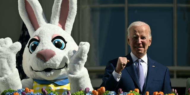 US President Joe Biden, alongside the Easter Bunny (L), gestures after speaking at the annual Easter Egg Roll on the South Lawn of the White House in Washington, DC, on April 10, 2023.