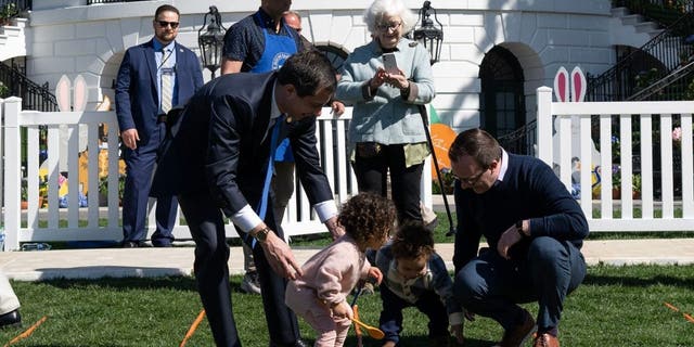 US Transportation Secretary Pete Buttigieg (L), with his husband Chasten Buttigieg (R) and their children, participates in the annual Easter Egg Roll on the South Lawn of the White House in Washington, DC, on April 10, 2023.