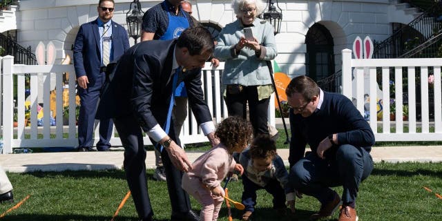 US Transportation Secretary Pete Buttigieg (L), with his husband Chasten Buttigieg (R) and their children, participates in the annual Easter Egg Roll on the South Lawn of the White House in Washington, DC, on April 10, 2023.