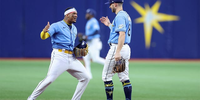 Wander Franco of the Tampa Bay Rays, left, celebrates a win over the Boston Red Sox with Brandon Lowe on April 10, 2023, in St. Petersburg, Florida.