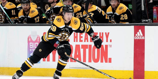 Boston Bruins right wing Tyler Bertuzzi picks up the puck during the playoff contest against the Florida Panthers on April 17, 2023, at TD Garden in Boston.