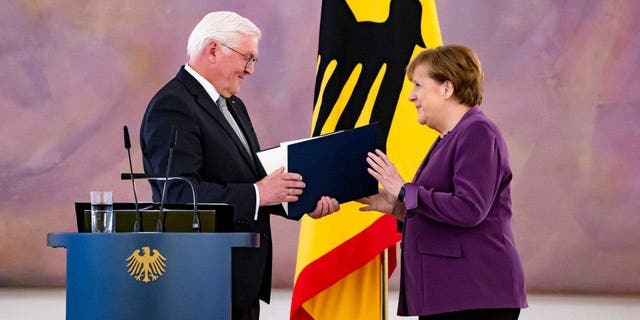 German President Frank-Walter Steinmeier awards the Grand Cross to former Chancellor Angela Merkel in Berlin on April 17, 2023.