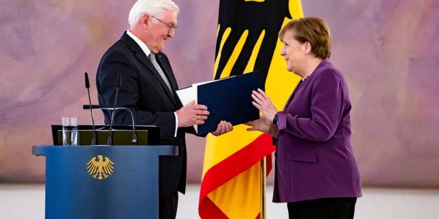German President Frank-Walter Steinmeier awards the Grand Cross to former Chancellor Angela Merkel in Berlin on April 17, 2023.
