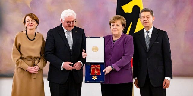First lady Elke Buendenbender, President Frank-Walter Steinmeier, former Chancellor Angela Merkel and her husband Joachim Sauer at the award ceremony in Berlin on April 17, 2023.