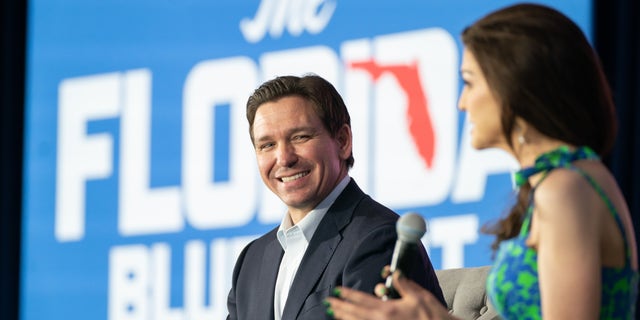 DeSantis sits on stage with his wife at Charleston event