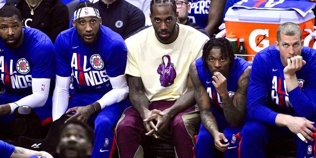 Kawhi Leonard looks on from the bench during a playoff game