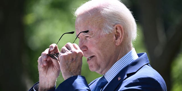 President Joe Biden putting on sunglasses