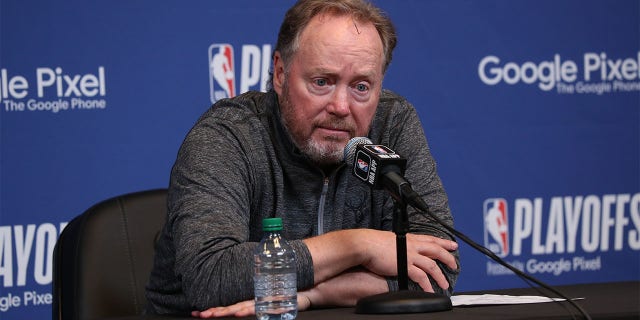 Mike Budenholzer talks to the media