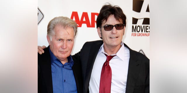 Martin Sheen and Charlie Sheen pose together on the red carpet.