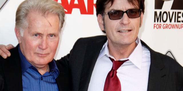 Martin Sheen and Charlie Sheen pose together on the red carpet.