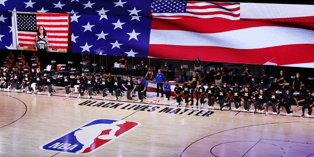 Players take a knee during the NBA bubble