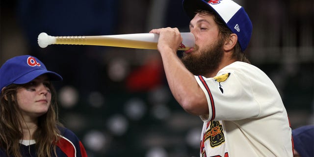 A Braves fan drinks beer following the Houston Astros' 9-5 win in game five of the World Series at Truist Park on Oct. 31, 2021, in Atlanta.