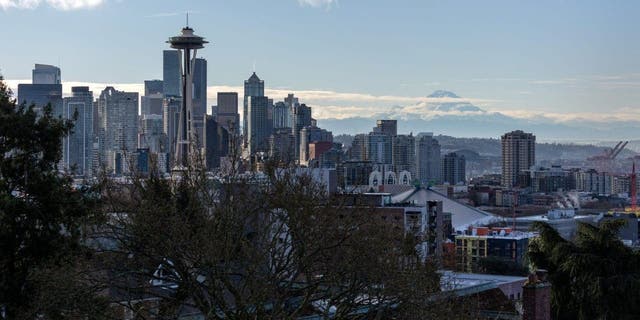 The Space Needle stands over the Seattle skyline as Mt. Rainier is seen in the background in Seattle, Washington, in King County.