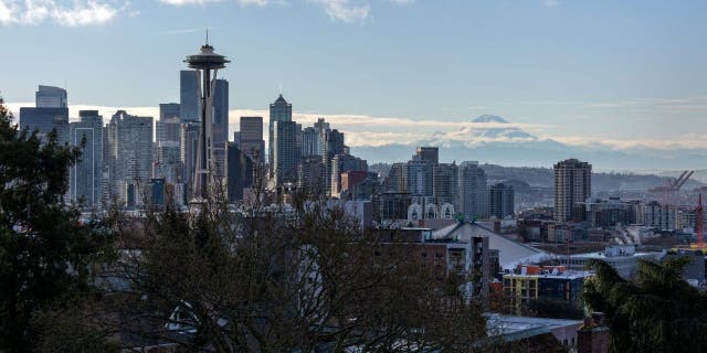 The Space Needle stands over the Seattle skyline as Mt. Rainier is seen in the background in Seattle, Washington, in King County.