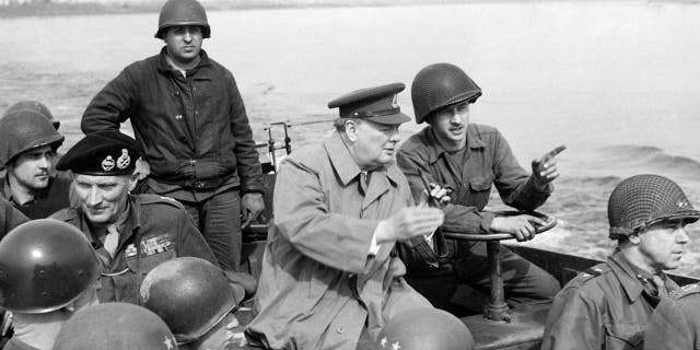 British Prime Minister Winston Churchill traveling with American GIs on a U.S. landing craft on the Rhine River with British Marshal Bernard Law Montgomery, U.S. General William Hood Simpson and U.S. General William Shaffer Key, March 25, 1945.