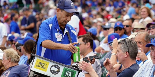 Beer vendor Rocco Caputo at work during a game between the Cubs and the St. Louis Cardinals at Wrigley Field on Aug. 23, 2022, in Chicago.
