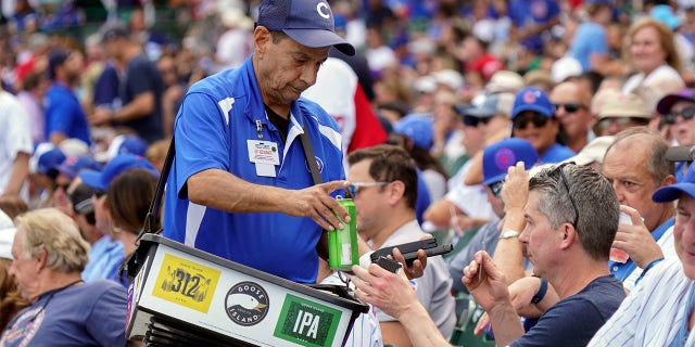 Beer vendor Rocco Caputo at work during a game between the Cubs and the St. Louis Cardinals at Wrigley Field on Aug. 23, 2022, in Chicago.