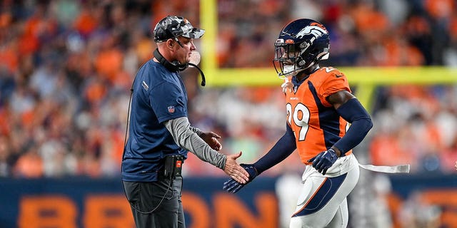 Head coach Nathaniel Hackett of the Denver Broncos congratulates cornerback Faion Hicks #29 after a play against the Minnesota Vikings in a preseason game at Empower Field at Mile High on August 27, 2022 in Denver, Colorado. 