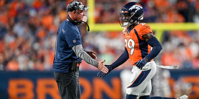 Head coach Nathaniel Hackett of the Denver Broncos congratulates cornerback Faion Hicks #29 after a play against the Minnesota Vikings in a preseason game at Empower Field at Mile High on August 27, 2022 in Denver, Colorado.